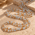 Blue and gold 2mm tie-on waist beads coiled together, showing the bead colours and pattern.